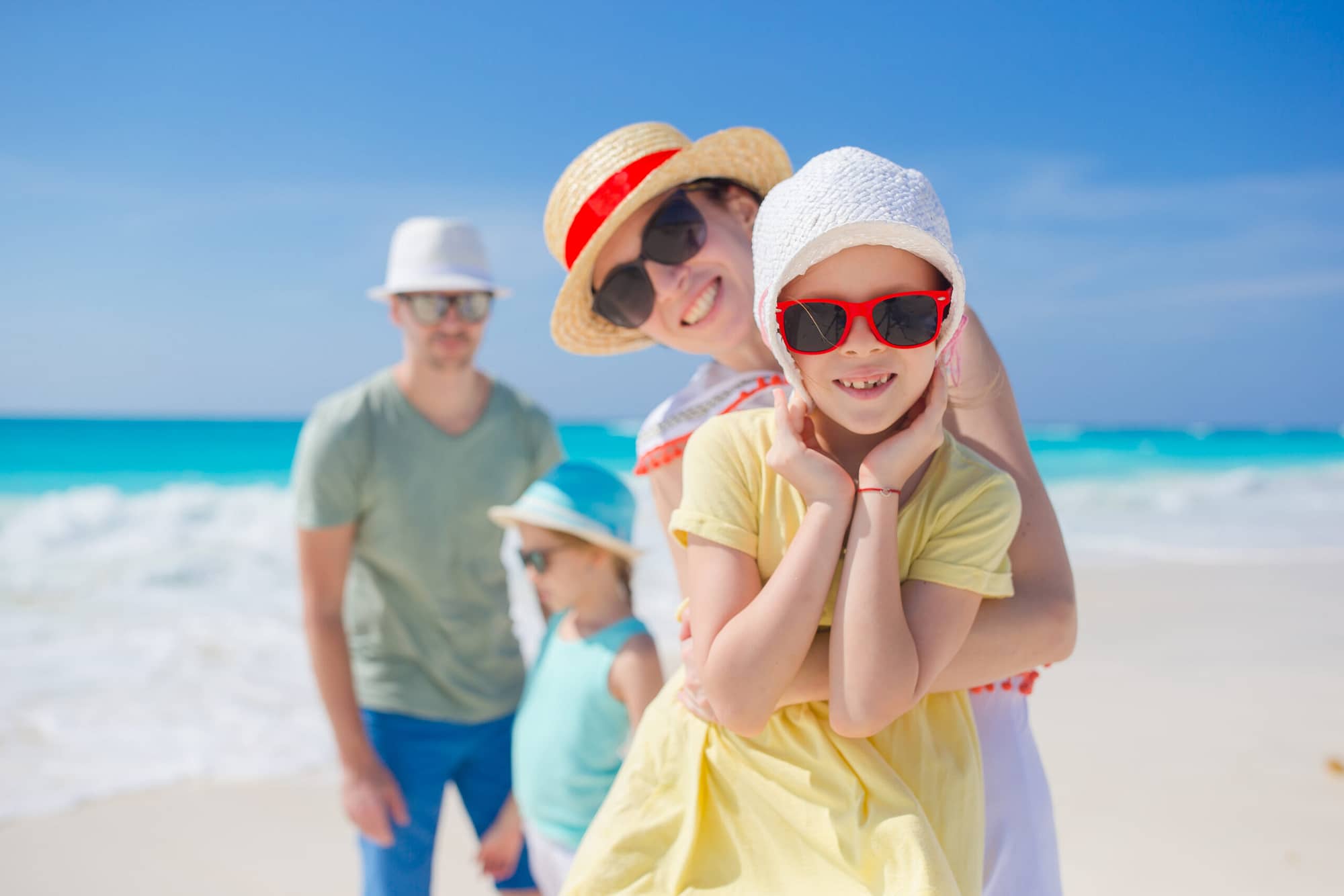 Young family of four on beach vacation